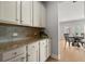 Charming kitchen featuring granite countertops, modern cabinets, and views of the breakfast nook at 7410 Ansley View Ln, Cumming, GA 30028