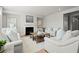 Cozy living room with a fireplace, comfortable seating, and bright natural light at 7410 Ansley View Ln, Cumming, GA 30028
