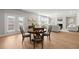 Open concept home with kitchen, dining and living area with hardwood flooring at 7410 Ansley View Ln, Cumming, GA 30028