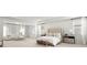Spacious main bedroom with a sitting area, tufted headboard, and lots of natural light at 7410 Ansley View Ln, Cumming, GA 30028