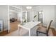Home office space featuring french doors, a white desk, and an adjacent view to the bathroom at 7410 Ansley View Ln, Cumming, GA 30028