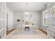Well-lit office with a large white desk, neutral decor, and ample natural light at 7410 Ansley View Ln, Cumming, GA 30028