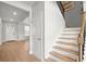Staircase with hardwood treads and white risers, offering a view into the bright entryway at 7410 Ansley View Ln, Cumming, GA 30028