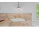 Elegant bathroom features a tiled soaking tub near a window at 80 Cliffcreek Trce, Atlanta, GA 30350