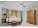 Large bedroom with decorative armoire and backyard views through French doors at 80 Cliffcreek Trce, Atlanta, GA 30350