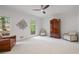 Spacious bedroom with neutral carpet, stylish furniture, and large windows overlooking lush trees at 80 Cliffcreek Trce, Atlanta, GA 30350