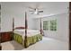 Bedroom featuring four poster bed and view of backyard at 80 Cliffcreek Trce, Atlanta, GA 30350