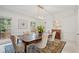 Bright dining room with decorative rug, a modern light fixture, and large windows with lush views at 80 Cliffcreek Trce, Atlanta, GA 30350