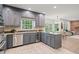 Kitchen with stainless steel appliances and granite counters, complemented by tiled floors and gray cabinets at 80 Cliffcreek Trce, Atlanta, GA 30350