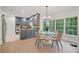 Kitchen with eat-in area featuring gray cabinets, stainless appliances, and large windows overlooking lush greenery at 80 Cliffcreek Trce, Atlanta, GA 30350
