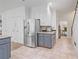 Kitchen with stainless steel refrigerator, gray lower cabinets, and stairs leading to a higher level at 80 Cliffcreek Trce, Atlanta, GA 30350