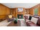 Cozy living room with wood paneled walls, fireplace, and built-in shelving around the fireplace at 80 Cliffcreek Trce, Atlanta, GA 30350