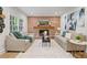 Living room with brick fireplace, plush sofas, neutral rug, and eye-catching artwork, creating a cozy and stylish space at 80 Cliffcreek Trce, Atlanta, GA 30350