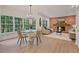 Open-concept living area with modern light fixtures, a brick fireplace, and ample seating at 80 Cliffcreek Trce, Atlanta, GA 30350