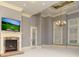 Large bedroom with fireplace, tray ceiling, chandelier, and lots of natural light at 9695 Almaviva Dr, Alpharetta, GA 30022