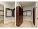 Spacious walk-in closet with built-in shelving and drawers at 9695 Almaviva Dr, Alpharetta, GA 30022