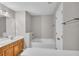 Bathroom with a soaking tub, wood vanity, and tile floors at 109 Creighton Ln, Marietta, GA 30008
