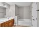 Bathroom with a soaking tub, wood vanity, and tile floors at 109 Creighton Ln, Marietta, GA 30008