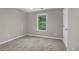 A serene bedroom featuring a window with a green view and neutral wall color at 109 Creighton Ln, Marietta, GA 30008