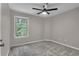Cozy bedroom featuring a modern ceiling fan and a window offering natural light at 109 Creighton Ln, Marietta, GA 30008
