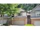 Charming townhouse featuring a two-car garage, brick accents, and mature trees at 109 Creighton Ln, Marietta, GA 30008