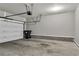 Clean garage with a white garage door and a trash can at 109 Creighton Ln, Marietta, GA 30008