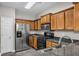 Well-lit kitchen with stainless steel appliances, wood cabinets, and granite countertops at 109 Creighton Ln, Marietta, GA 30008