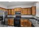 Well-lit kitchen with stainless steel appliances, wood cabinets, and granite countertops at 109 Creighton Ln, Marietta, GA 30008