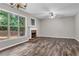 Bright living room featuring hardwood floors, a fireplace, and large windows overlooking the backyard at 109 Creighton Ln, Marietta, GA 30008