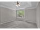 Spacious carpeted main bedroom with a ceiling fan and natural light at 109 Creighton Ln, Marietta, GA 30008
