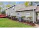 Backyard showcasing the home's siding, deck, and lawn at 110 Paddock Trl, Peachtree City, GA 30269