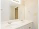 Bathroom featuring a double sink, large mirror, and a two-bulb light fixture at 110 Paddock Trl, Peachtree City, GA 30269