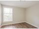 Bright bedroom featuring wood-look floors and a window with natural light at 110 Paddock Trl, Peachtree City, GA 30269