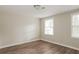 Spacious bedroom with wood-look floors and two large windows for ample natural light at 110 Paddock Trl, Peachtree City, GA 30269