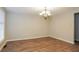 Spacious dining room with wood-look flooring, chandelier, and abundant natural light at 110 Paddock Trl, Peachtree City, GA 30269