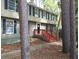 Charming two-story home featuring a classic design and inviting front porch with red stairs at 110 Paddock Trl, Peachtree City, GA 30269