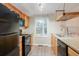 Functional kitchen features black appliances, wooden cabinets, and sleek countertops at 110 Paddock Trl, Peachtree City, GA 30269