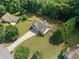 Aerial shot of a beautiful home, featuring a big yard, wooden fence, and lush greenery surrounding the property at 2355 Woodland Hills Dr, Cumming, GA 30040