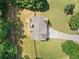 Aerial view showcasing the roof and the surrounding yard with mature trees and a driveway at 2355 Woodland Hills Dr, Cumming, GA 30040