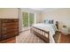 Cozy bedroom with natural light, a patterned rug, and a charming wooden dresser at 2355 Woodland Hills Dr, Cumming, GA 30040