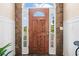 Beautiful front door with sidelights and transom window and stone surround at 2355 Woodland Hills Dr, Cumming, GA 30040
