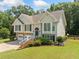 Charming split-level home with stone accents, two-car garage and inviting, red-painted staircase at 2355 Woodland Hills Dr, Cumming, GA 30040