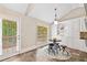 Eat-in kitchen with a round table, and white cabinets, near a door with a view of trees at 2355 Woodland Hills Dr, Cumming, GA 30040
