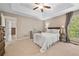 Spacious main bedroom features a trey ceiling, ceiling fan, carpet, and two large windows at 2355 Woodland Hills Dr, Cumming, GA 30040