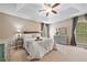 Main bedroom featuring a tray ceiling, ceiling fan, neutral walls, and lots of natural light at 2355 Woodland Hills Dr, Cumming, GA 30040