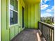 View of an outdoor balcony area with painted green siding, and a wooded view beyond at 2022 Bixby Byway Se Rd, Atlanta, GA 30317