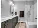 Modern bathroom with a walk-in glass shower, dual sink vanity, and tile flooring at 2022 Bixby Byway Se Rd, Atlanta, GA 30317