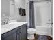 Clean bathroom featuring updated vanity with sink and a shower over bath with modern curtain at 2022 Bixby Byway Se Rd, Atlanta, GA 30317
