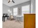 Neutral bedroom space with two windows, wood dresser, and overhead ceiling fan at 2022 Bixby Byway Se Rd, Atlanta, GA 30317
