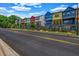 View of a row of colorful, modern townhomes with balconies and updated exteriors at 2022 Bixby Byway Se Rd, Atlanta, GA 30317
